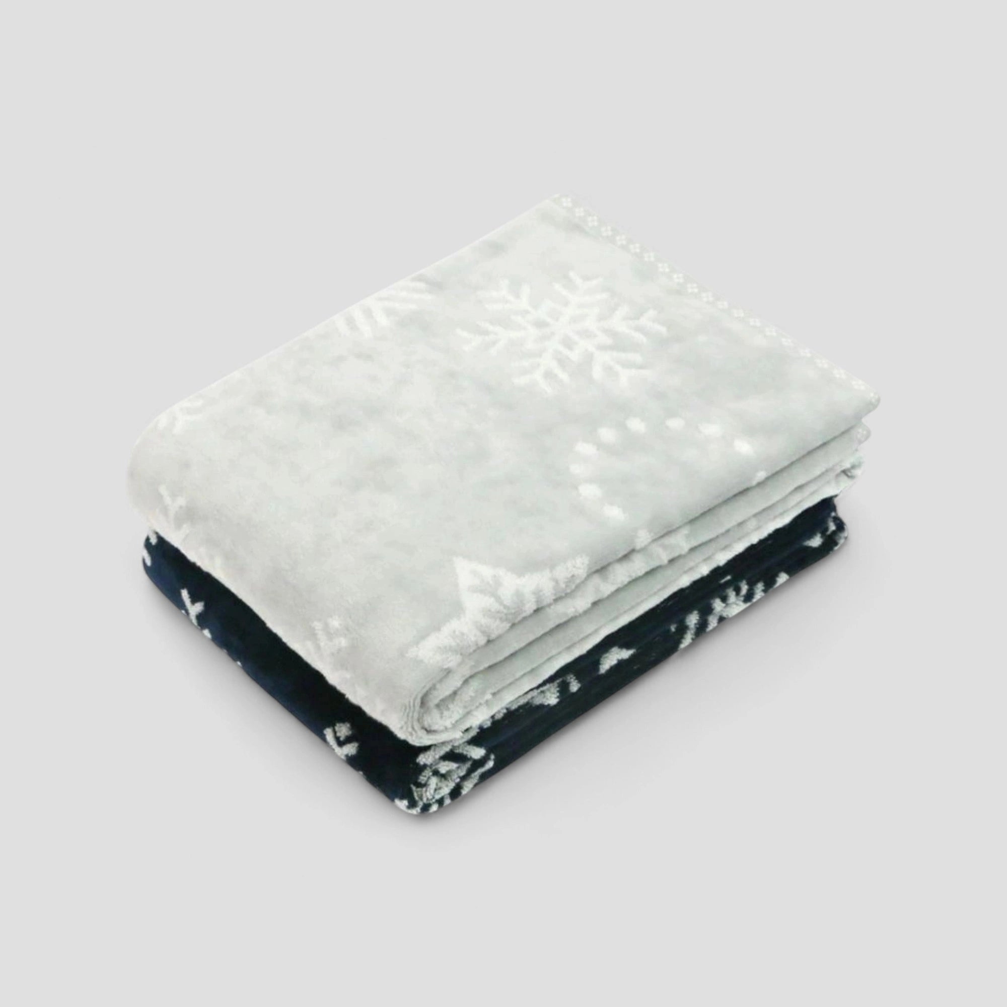 Two Imabari towel, one light gray and one navy with white snowflake patterns, stacked on a light gray background.