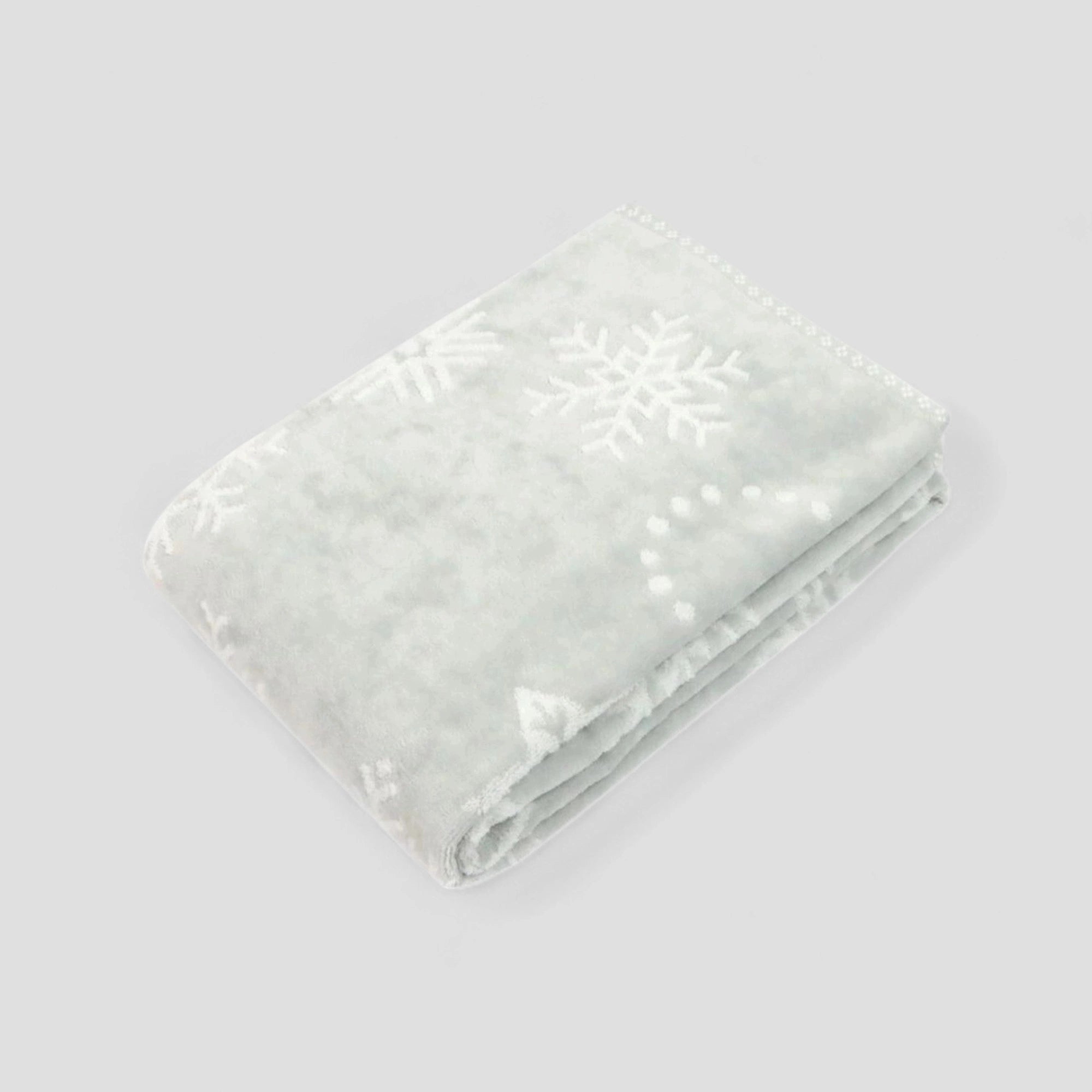 Folded light gray Imabari towel with snowflake pattern on a light gray background