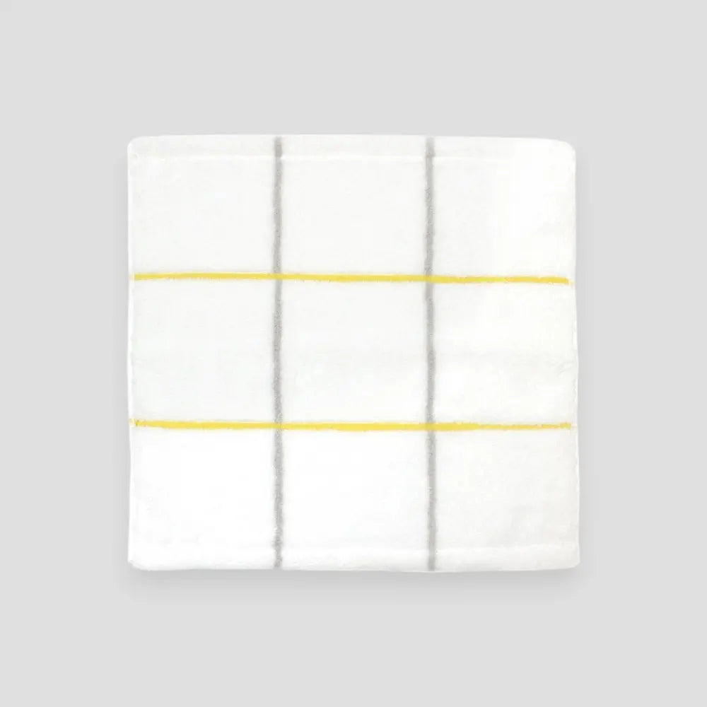 Square white Imabari towel with yellow stripe on gray background