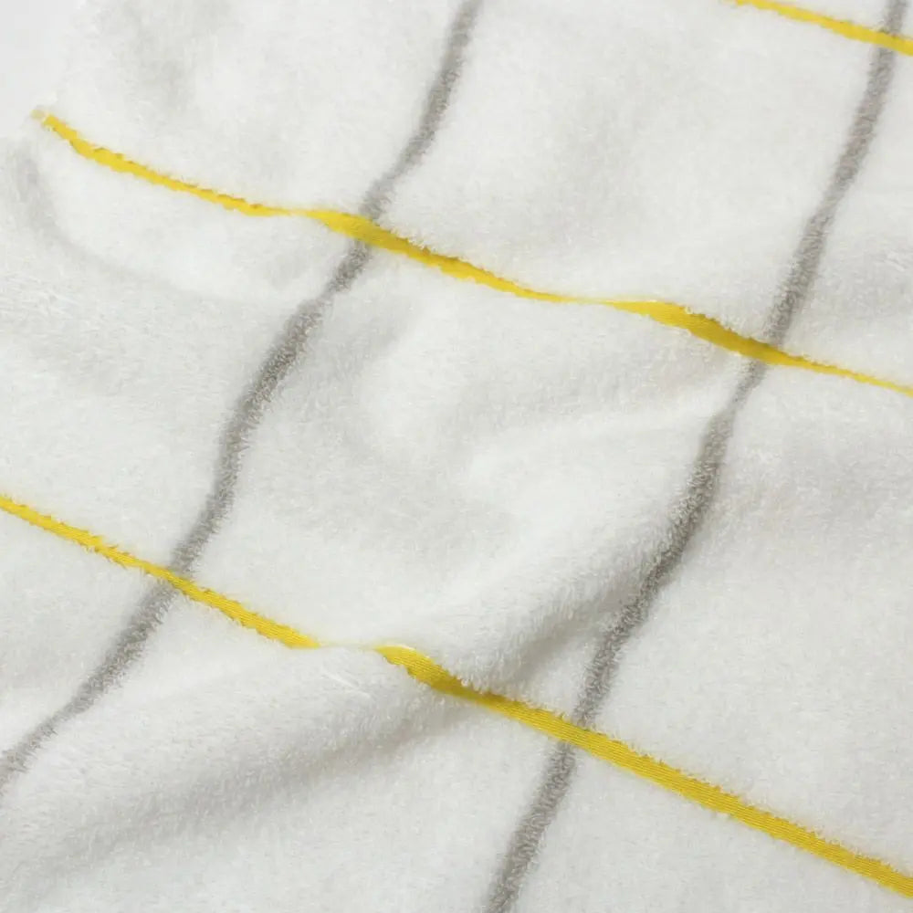 Close-up of  cotton fabric of white Imabari towel with yellow and gray line