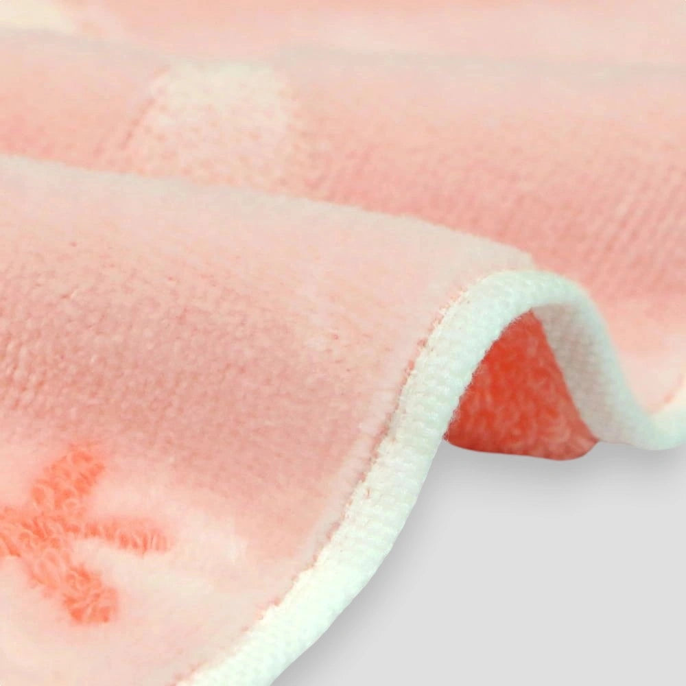 Close up of side of a  pink floral Imabari towel 