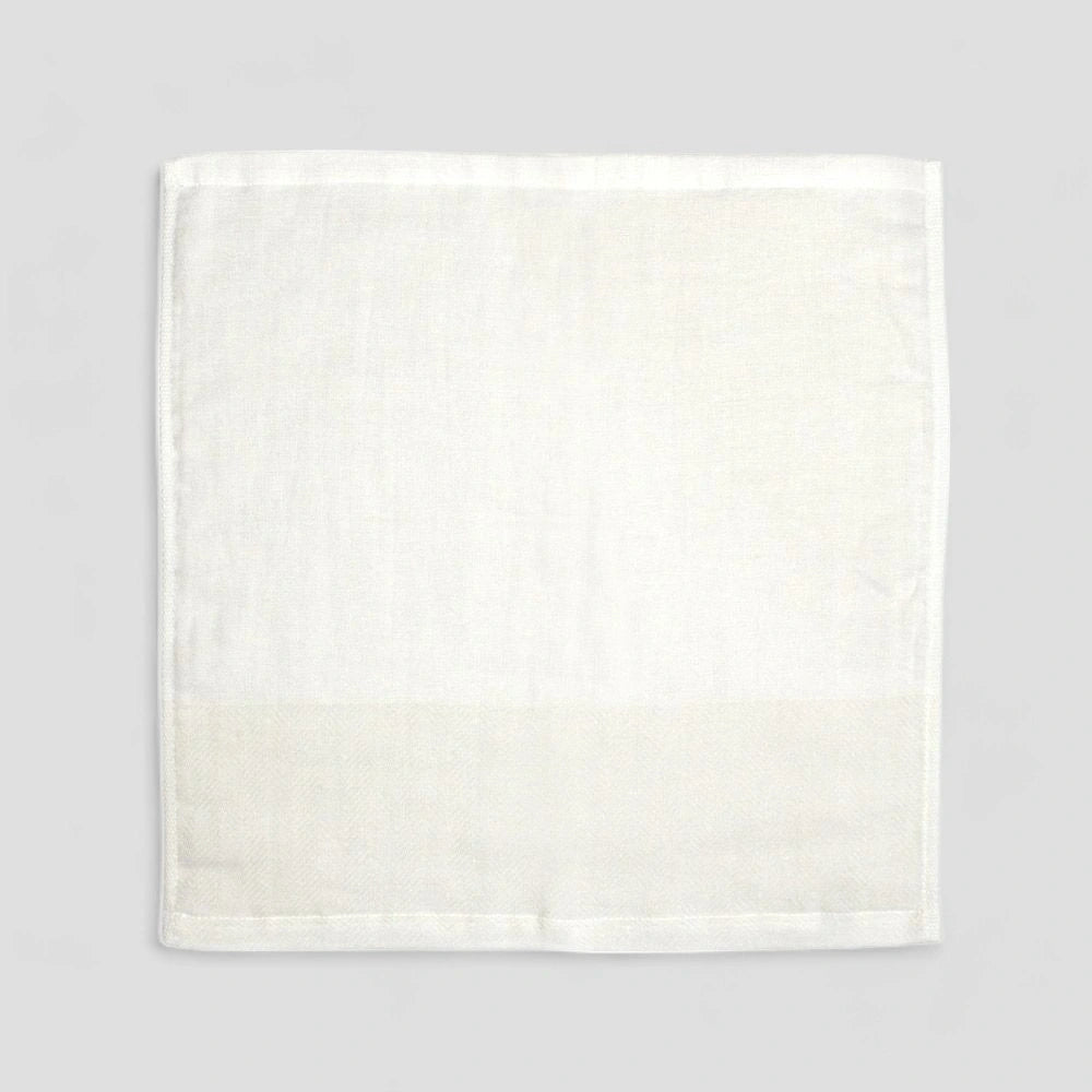 White Imabari towel with a subtle herringbone pattern on a light gray background.