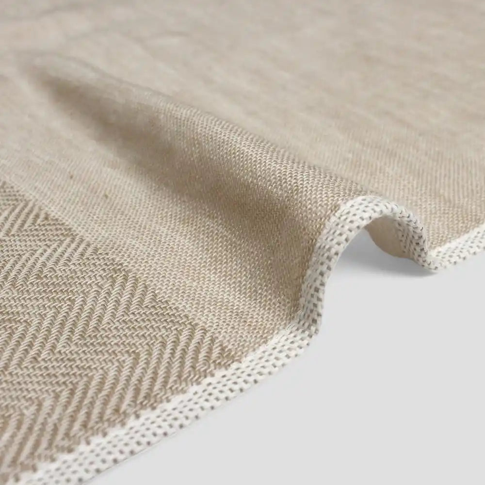 Close-up of a beige  Imabari towel corner on a light gray background