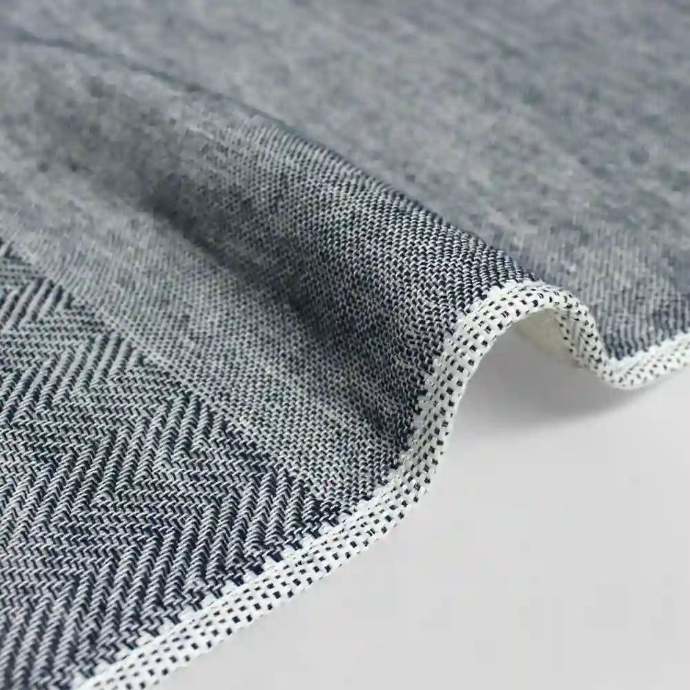 Close-up of a navy  Imabari towel corner on a light gray background