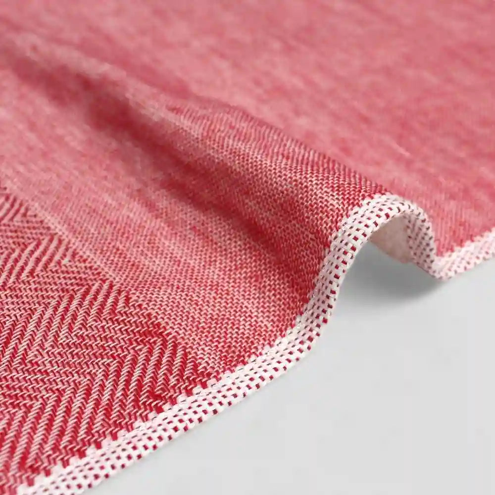 Close-up of a red  Imabari towel corner on a light gray background