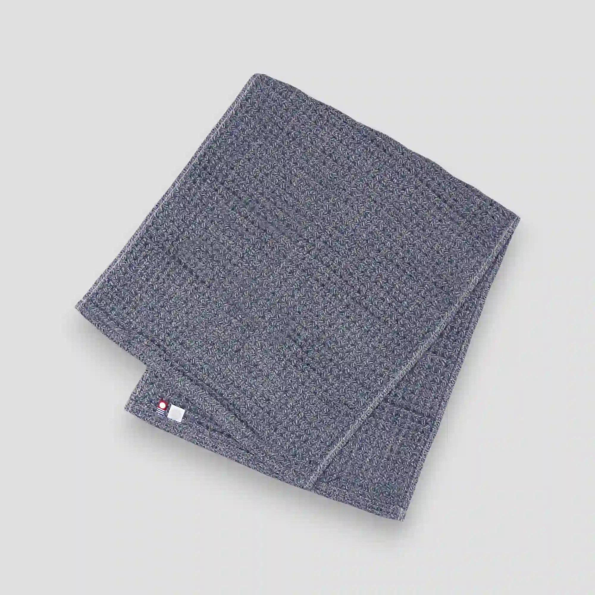 Navy waffle Imabari towel on a gray background