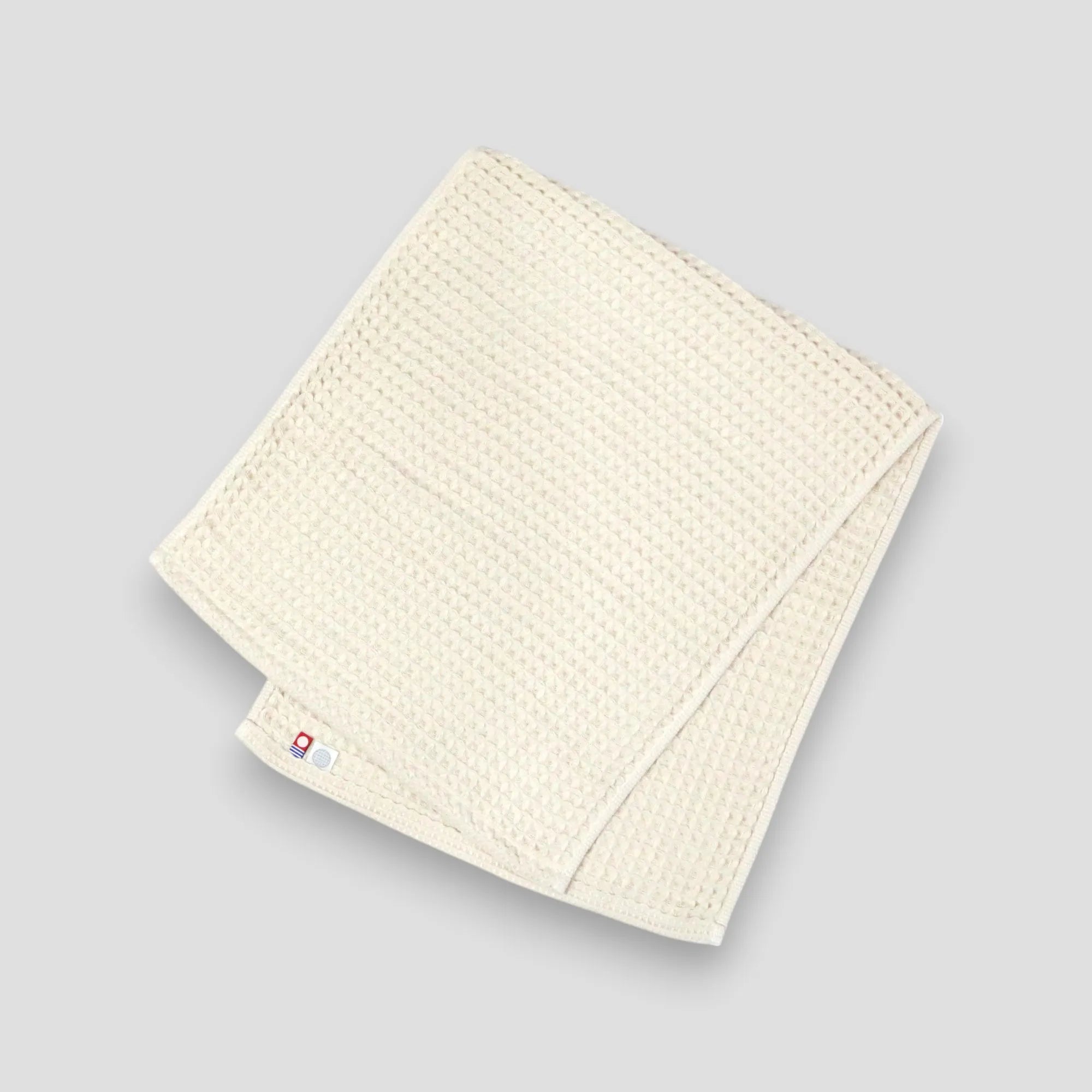 Off-white waffle Imabari towel on a gray background