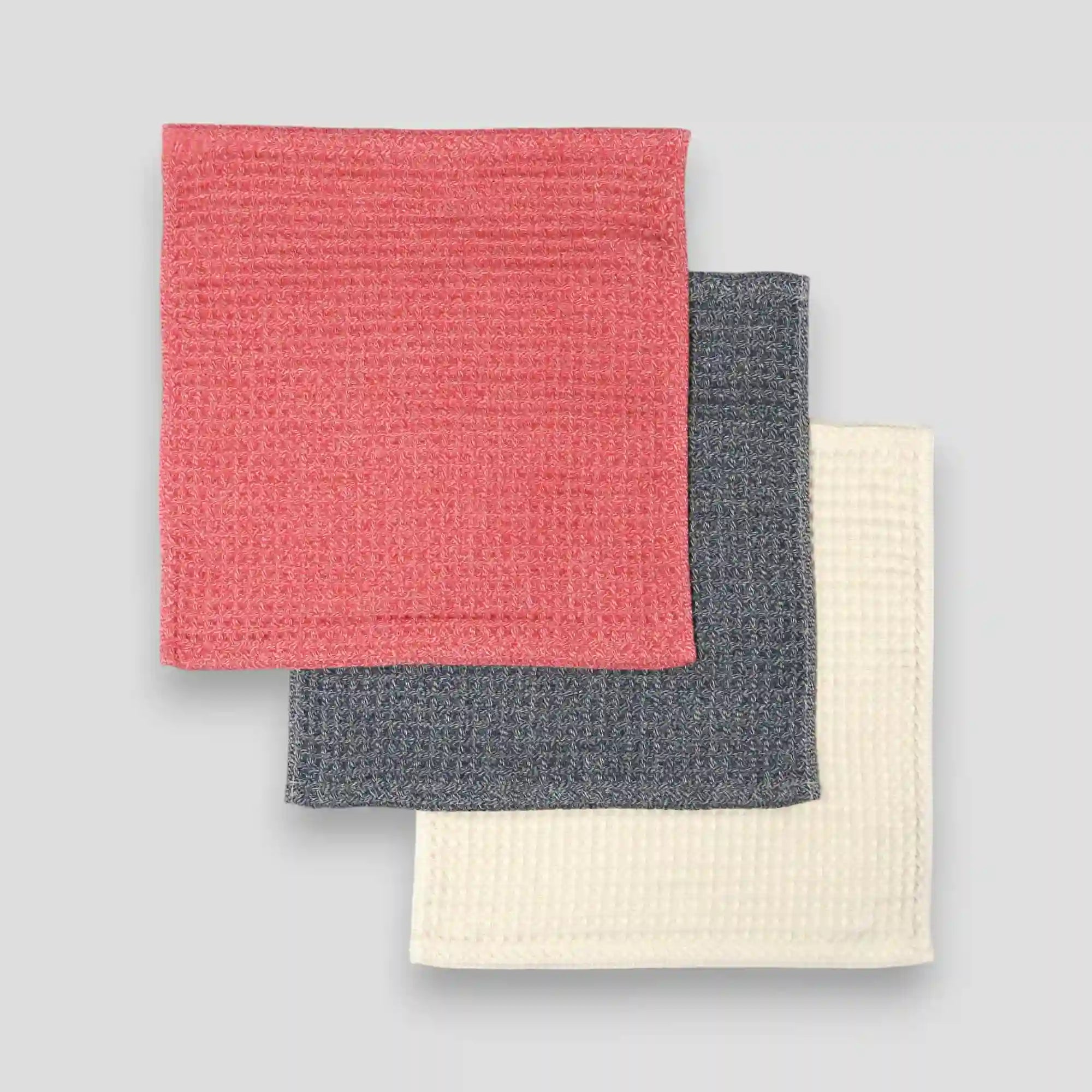 Set of colorful waffle Imabari towels stacked on a light gray background