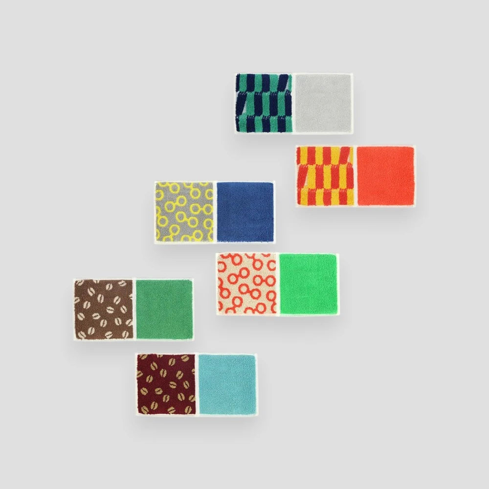 A collection of compact Imabari towel in various vibrant patterns, displayed against a white background.