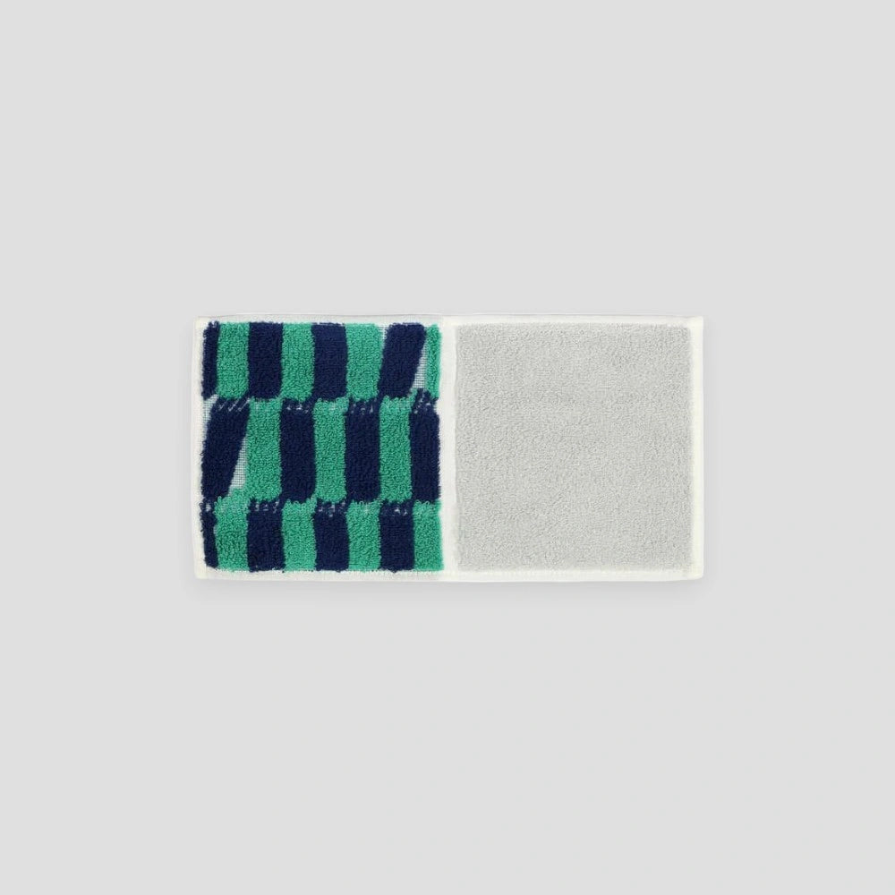 A compact Imabari towel in navy and green vibrant patterns, displayed against a white background.