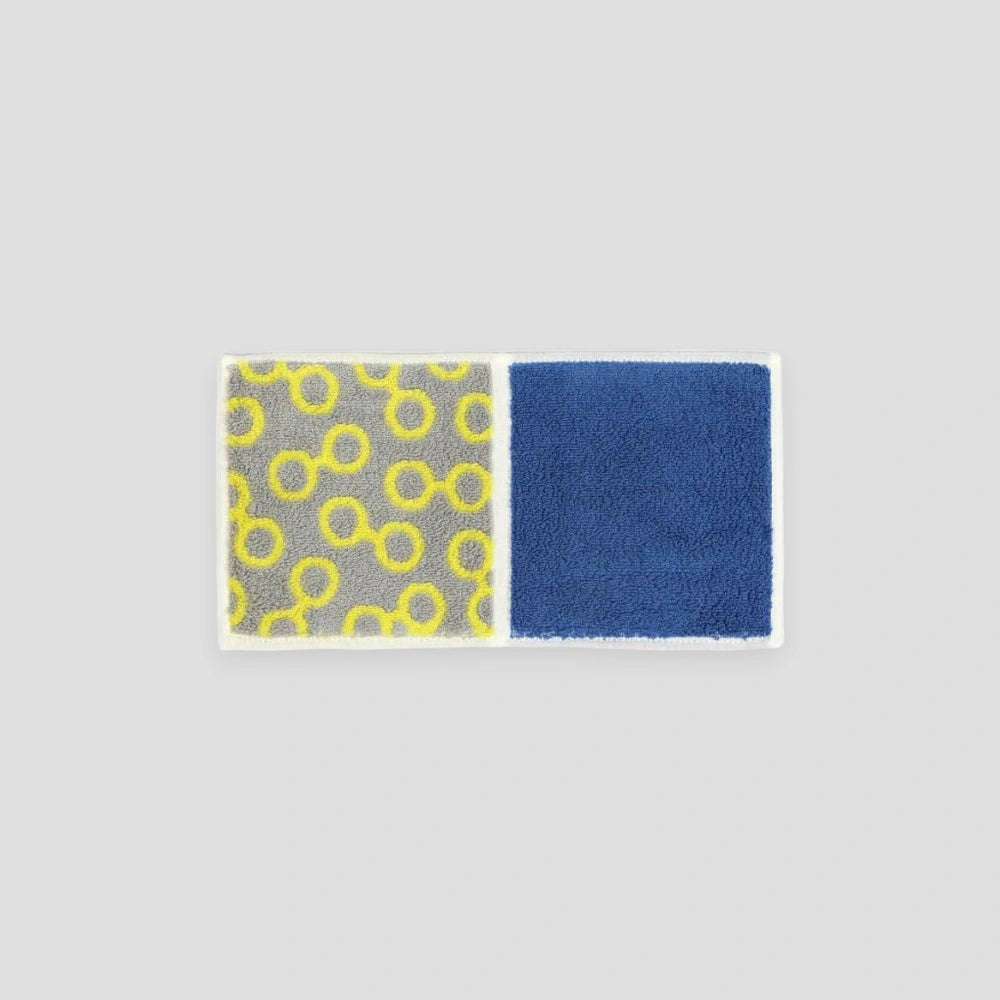 A compact Imabari towel in yellow glassese patterns, displayed against a white background.