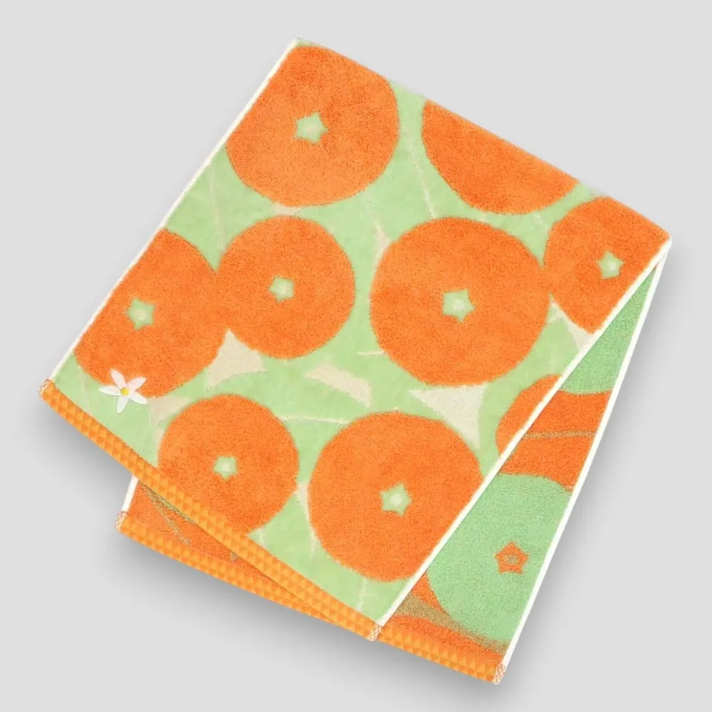Orange Imabari towel with Iyokan pattern and a small white embroidery