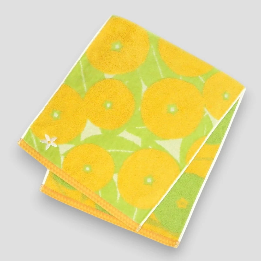 Yellow Imabari towel with Iyokan pattern and a small white embroidery