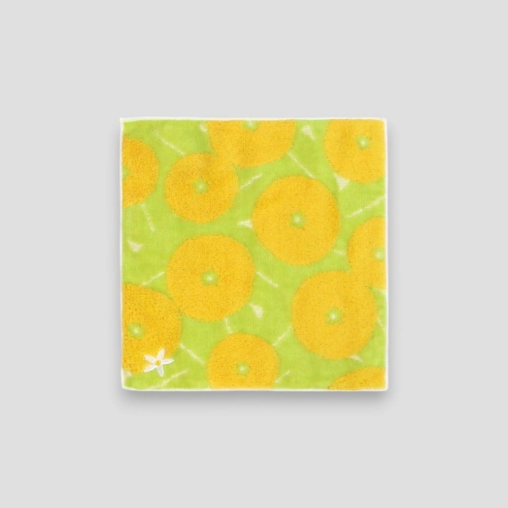 A small square yellow Iyokan patterned Imabari towel with a small white flower