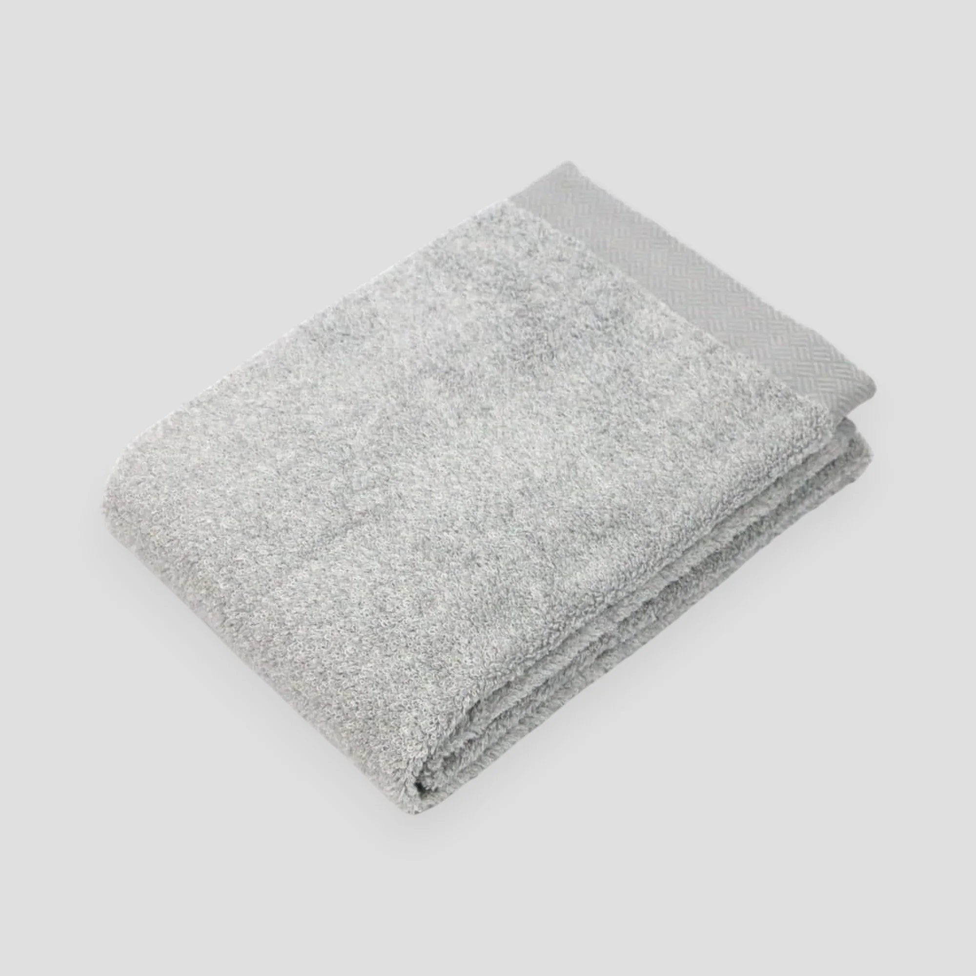 Folded gray Imabari towel with light gray background.
