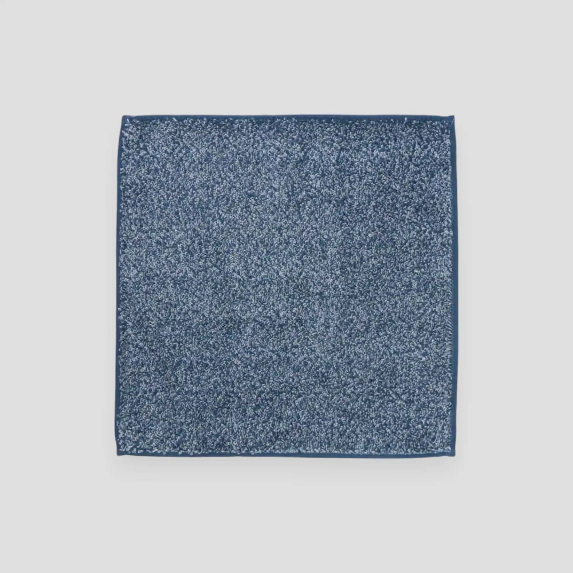 Square navy Imabari towel with light gray background.
