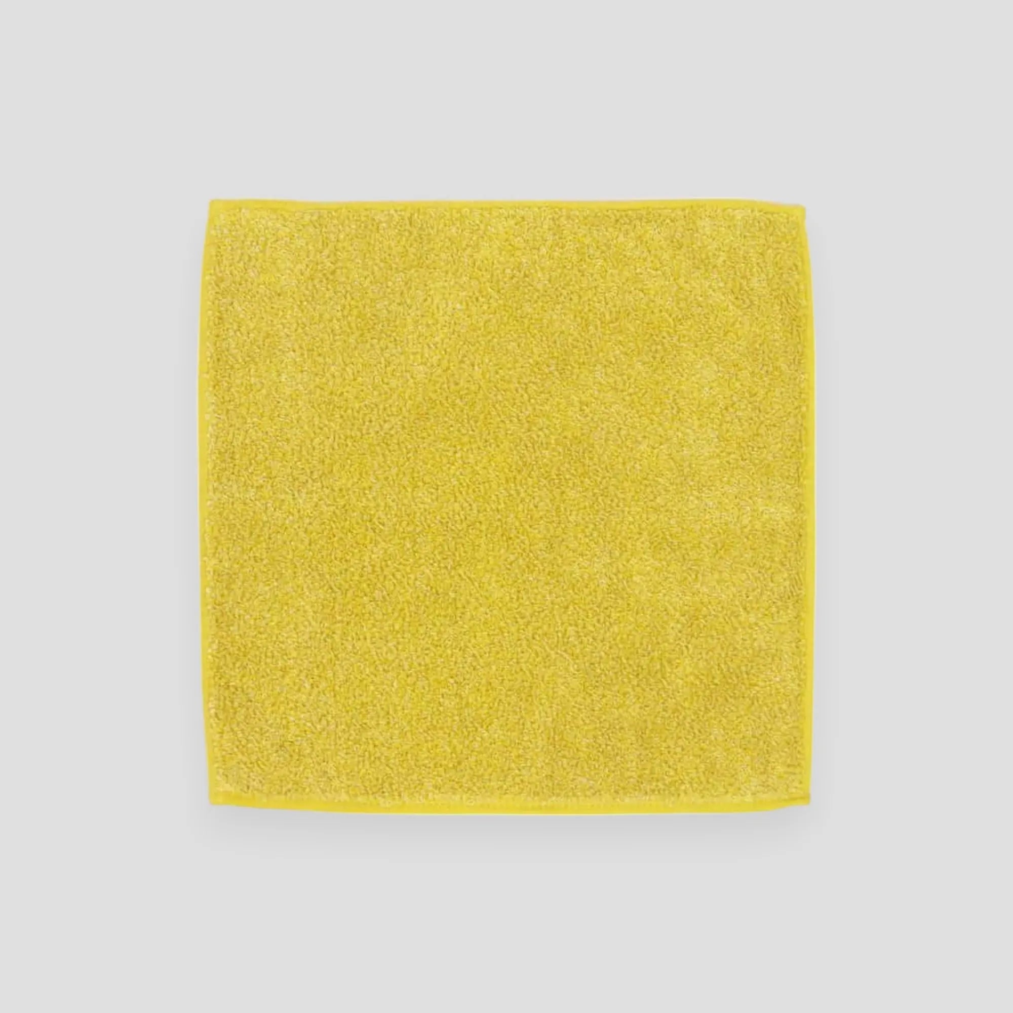 Square yellow Imabari towel with light gray background.