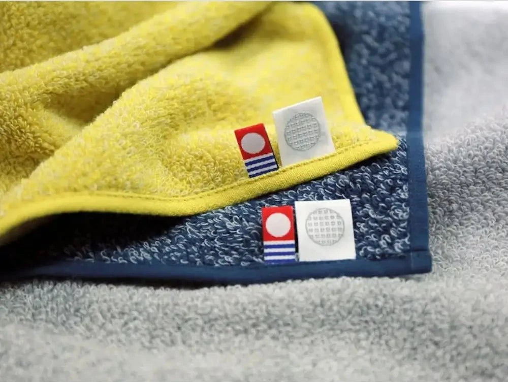 Close-up of labels of Imabari towel mark and IORI brand logo. 