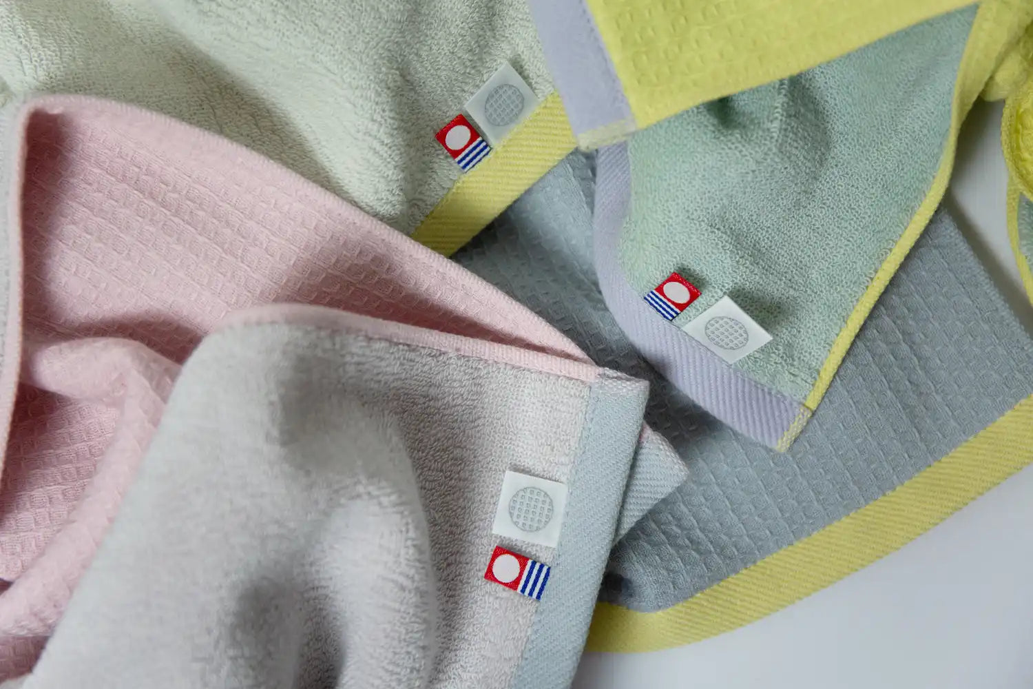 Close-up of showing both sides of the Imabari sports towels, with the brand label featured