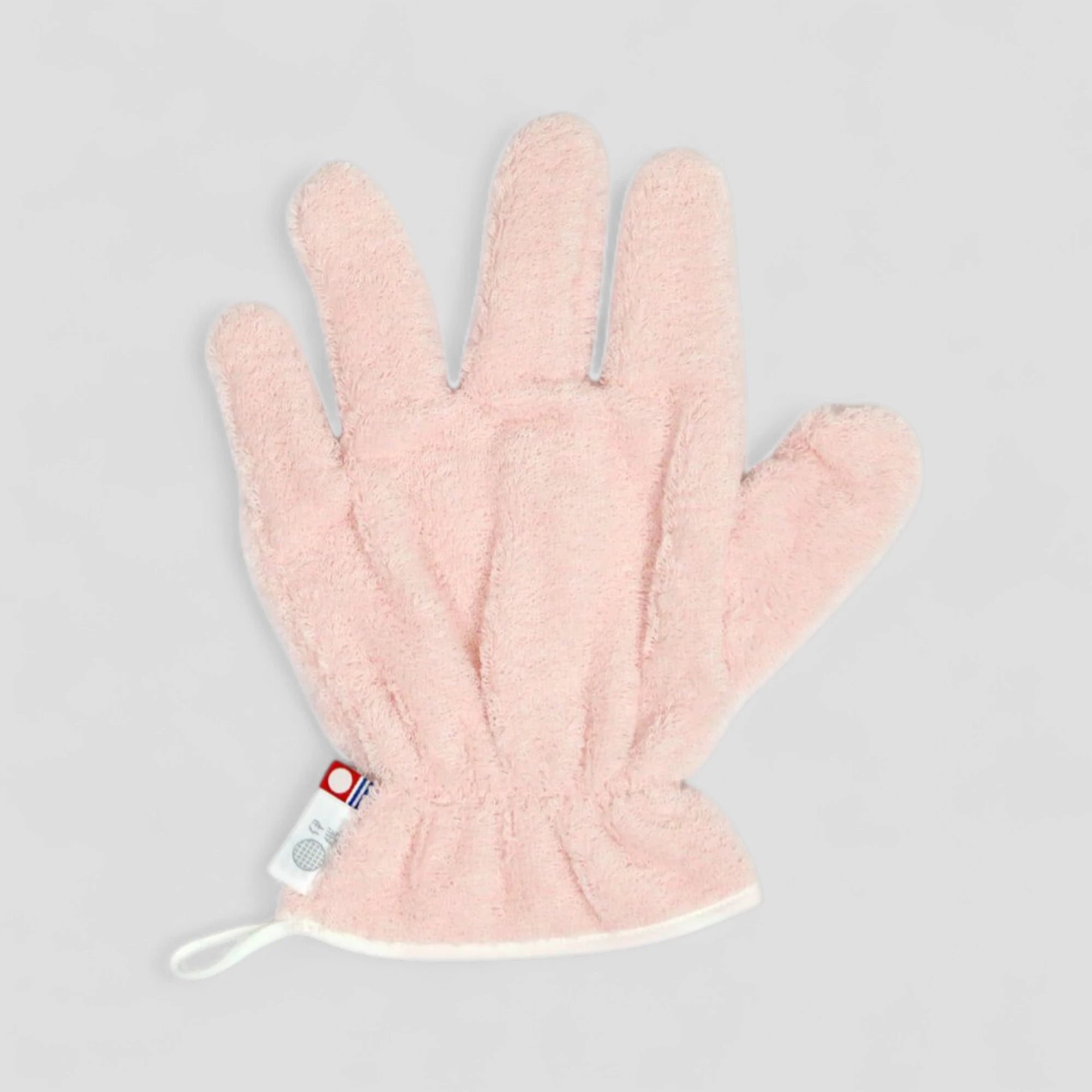 Pink Imabari towel hair-dry-glove with a brand label on a light gray background