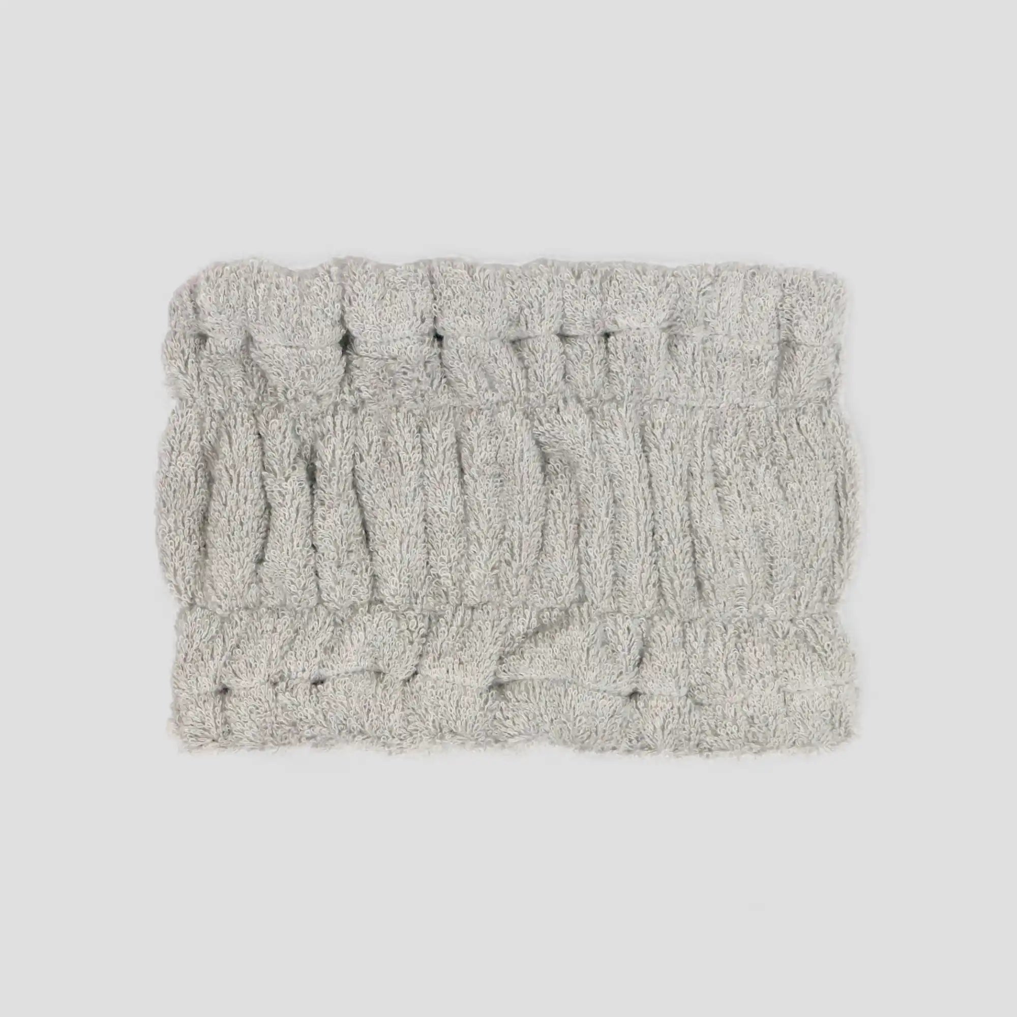 Gray Imabari towel textured head band t on a light gray background