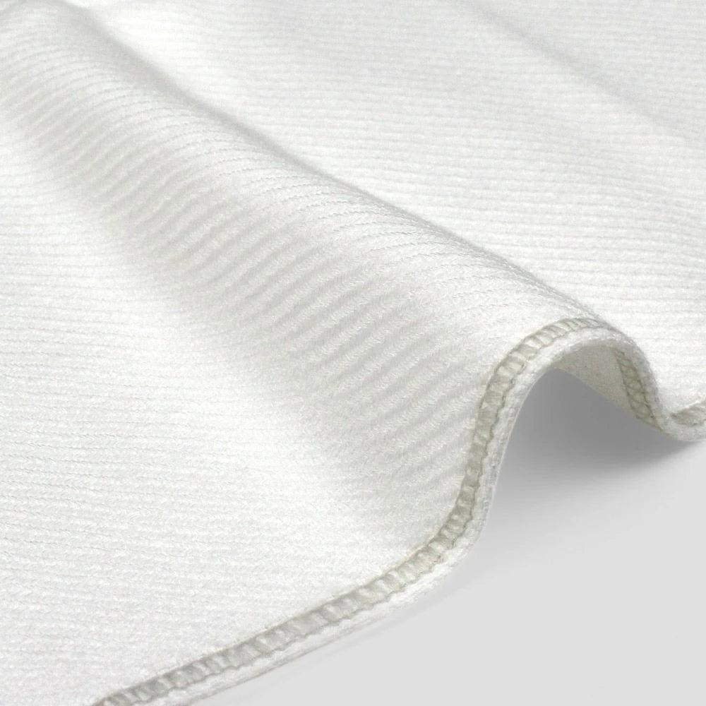 Close-up of a side of white Imabari towel made from cotton gauze.
