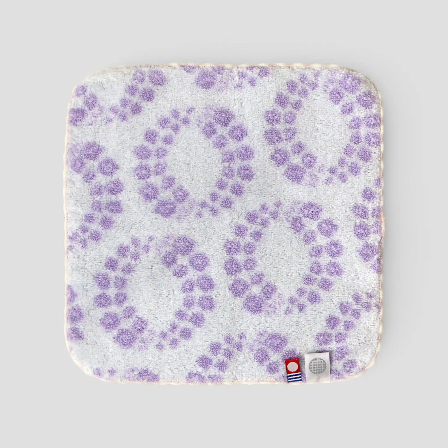 Back-side of Imabari towel with purple floral pattern on a light gray background