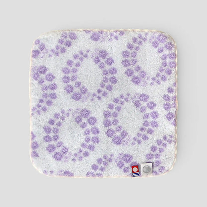 Back-side of Imabari towel with purple floral pattern on a light gray background