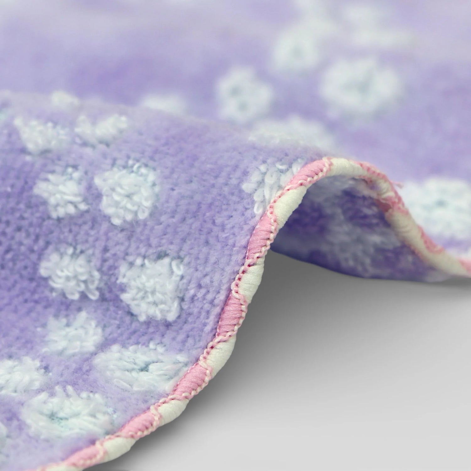 Purple Imabari towel with white floral patterns on a light purple background