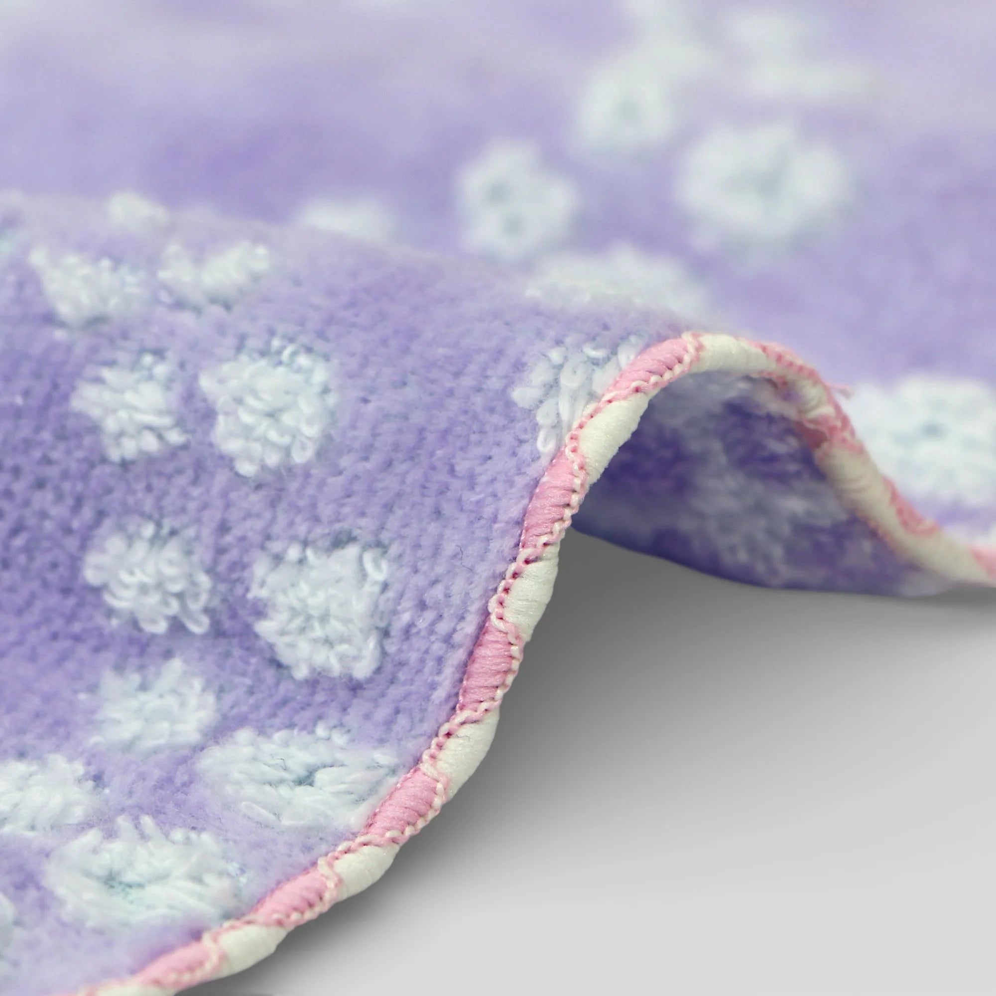 Purple Imabari towel with white floral patterns on a light purple background