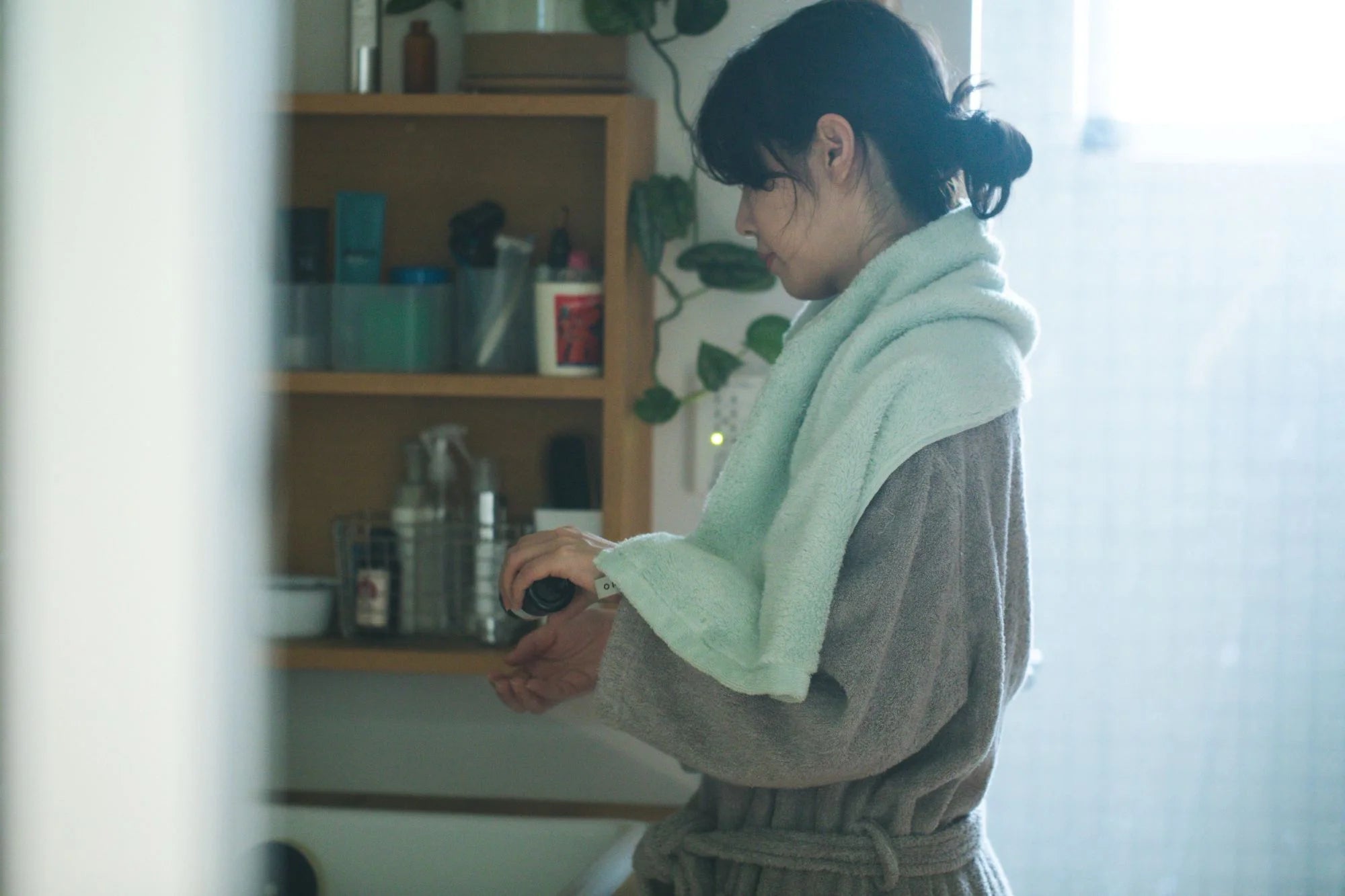 Person hanging her shoulder with light blue Imabari towel 