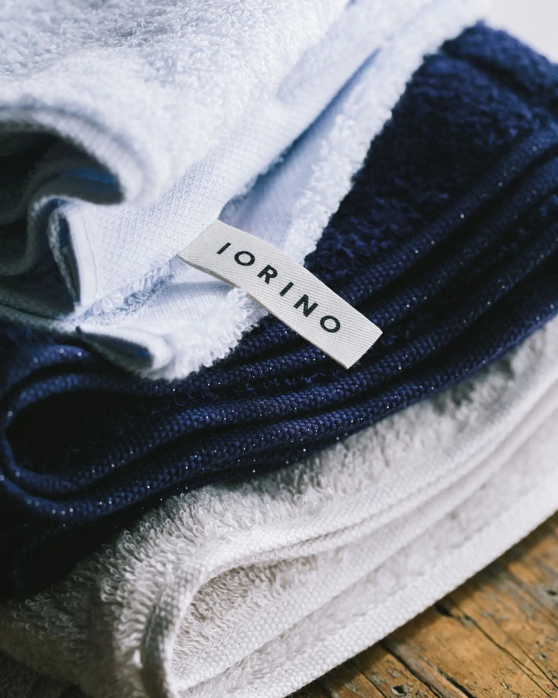 Folded blue and white Imabari towels with a &