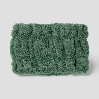 Green textured Imabari towel head band on a light gray background