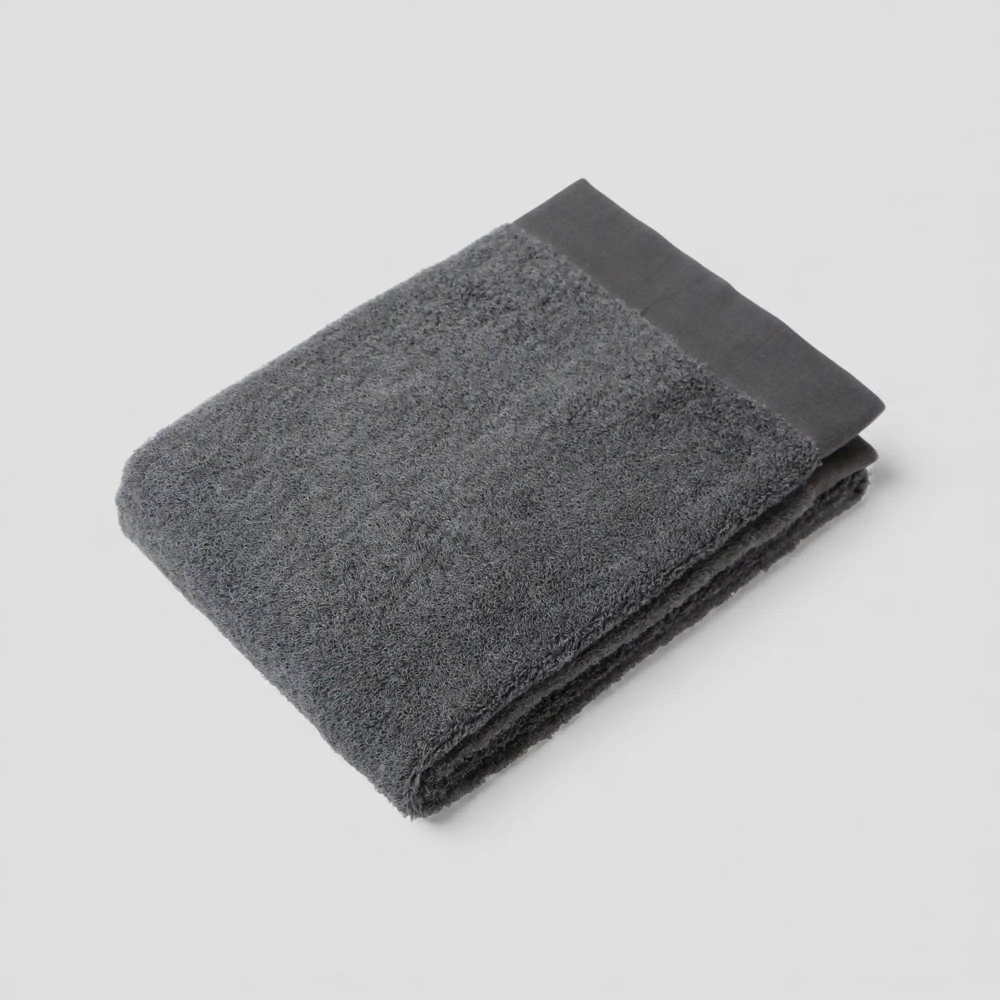 Folded gray Imabari towel on a light gray background