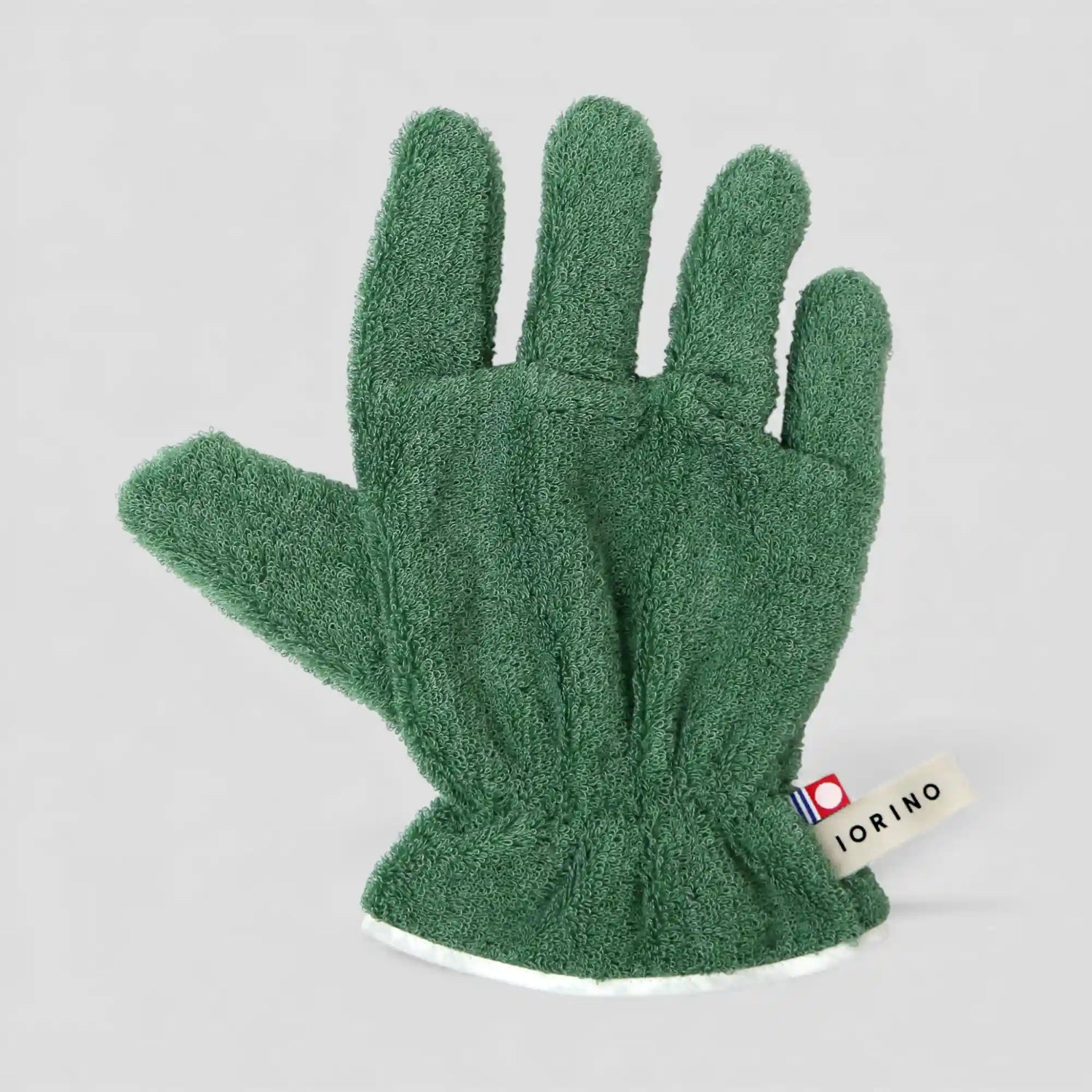 Green Imabari towel glove on a light gray background with a visible brand label.
