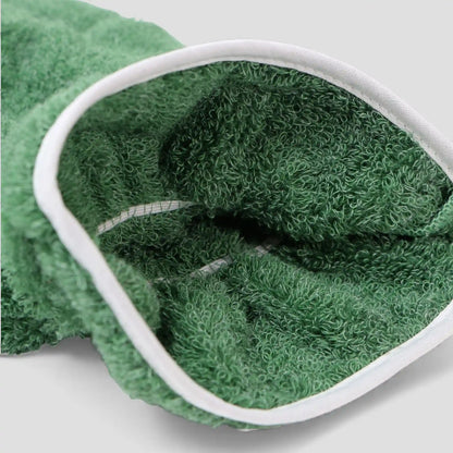 Green Imabari towel glove with white rim on a light gray background