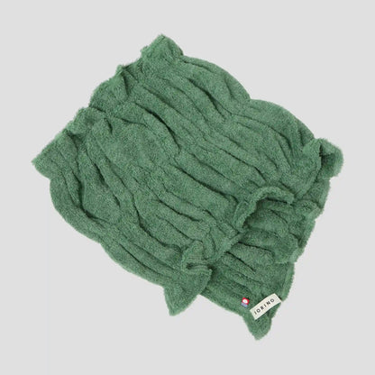 Green Imabari towel with a brand label on a light gray background