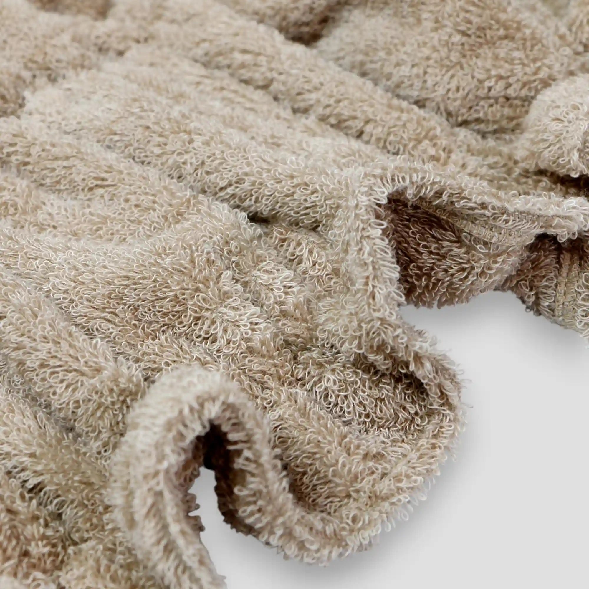 Close-up of a beige textured Imabari towel on a white background