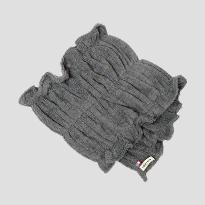 Gray Imabari towel with a brand label on a light gray background