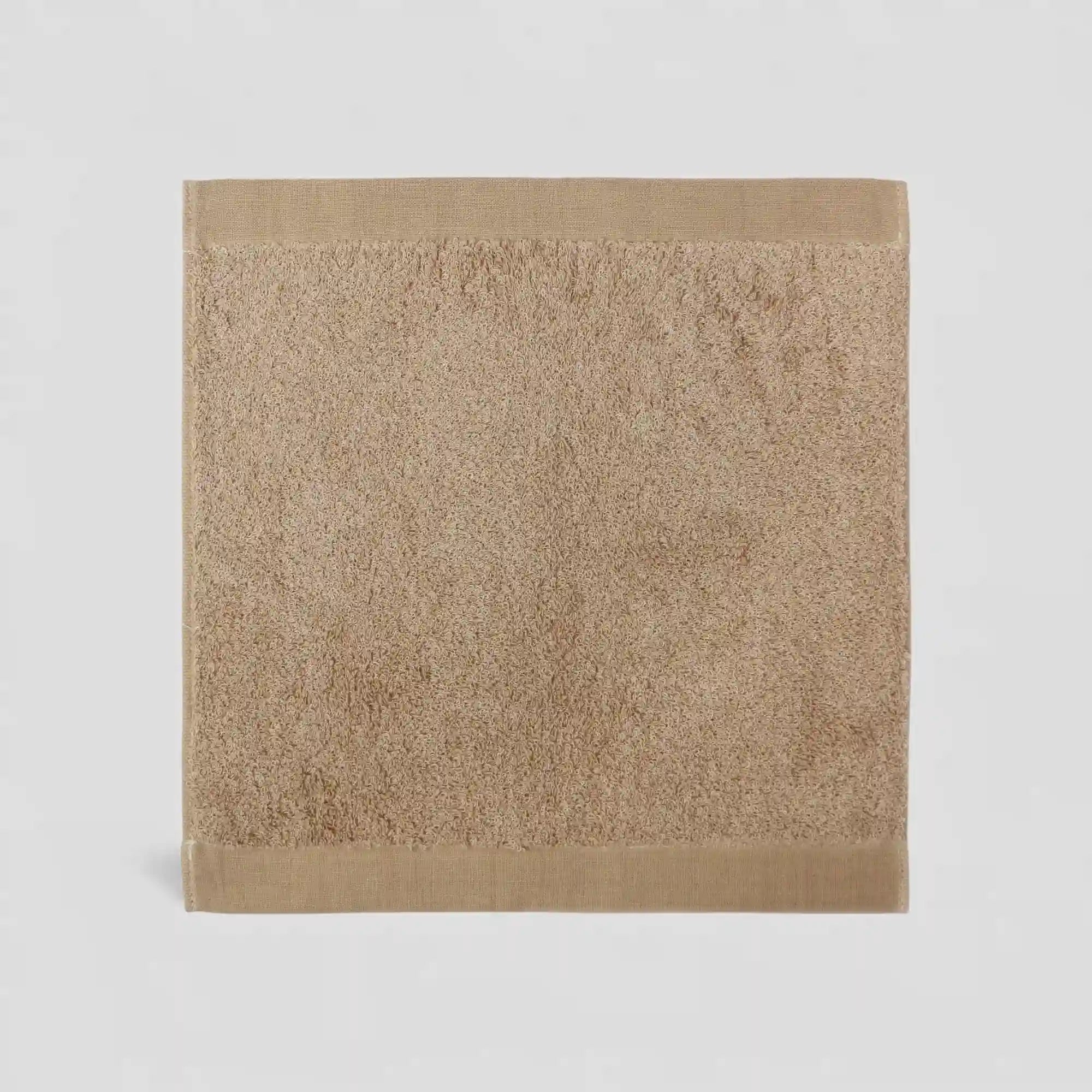 Beige Imabari towel on a light gray background
