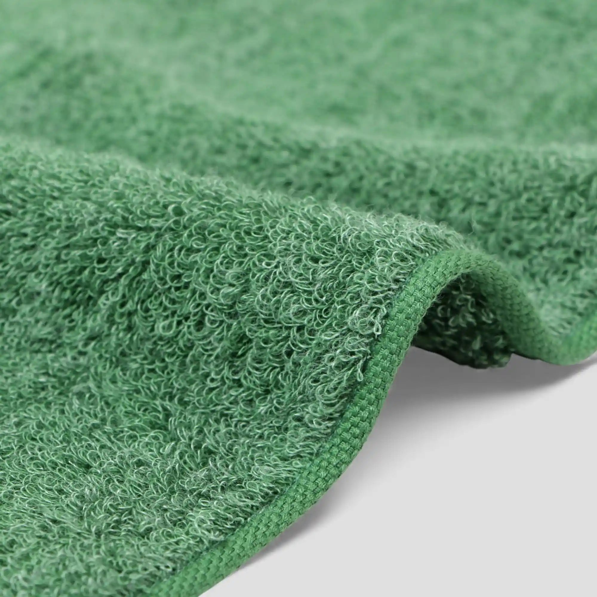 Close-up of a green  Imabari towel corner on a light background