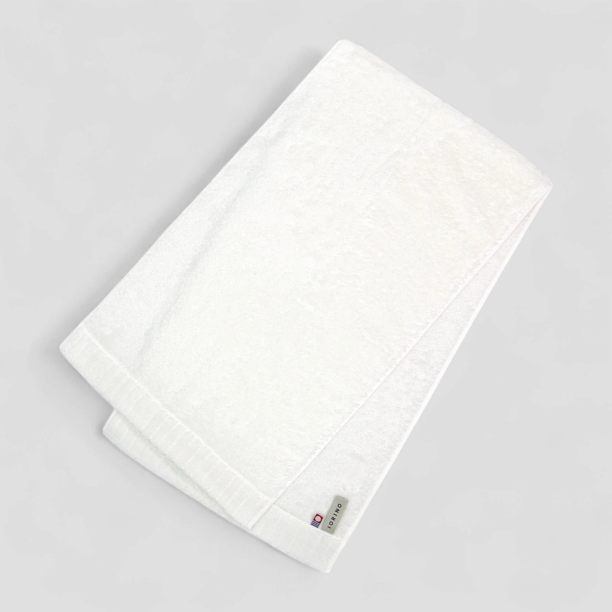 White Imabari towel with a brand label on a light gray background