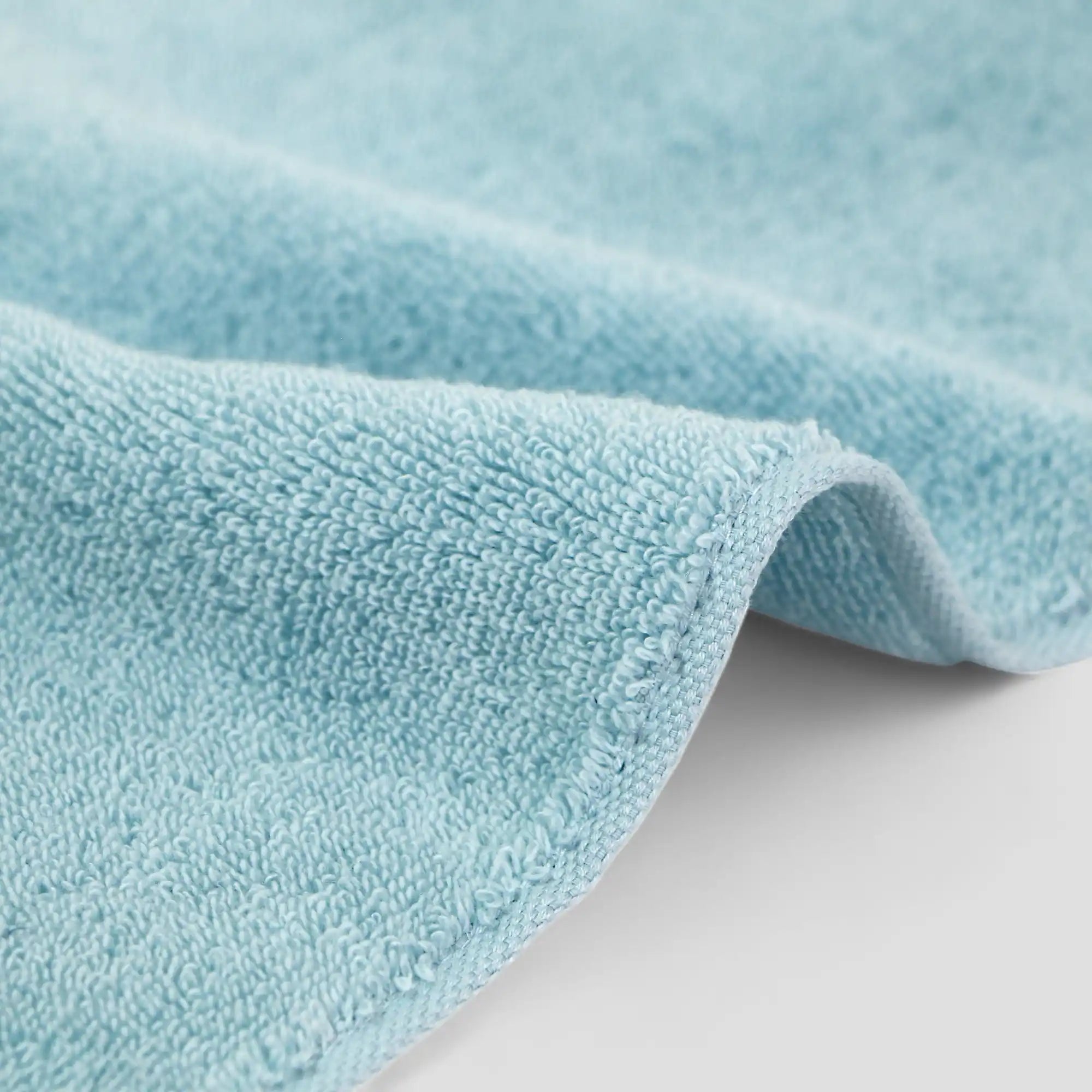 Close-up of a light blue Imabari towel on a white background