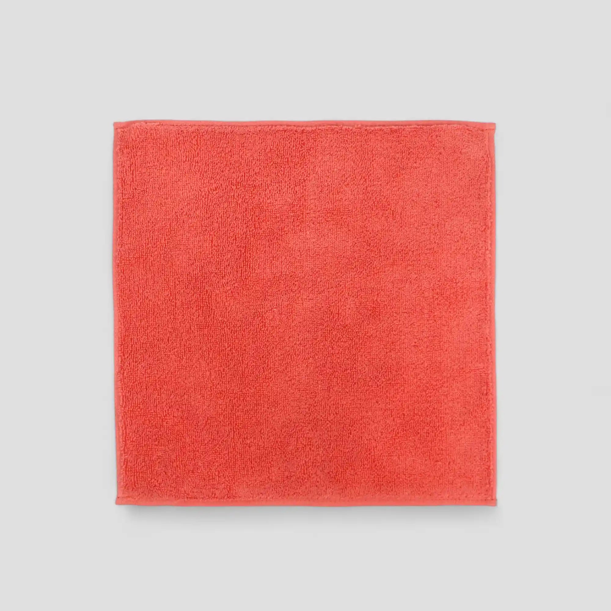 Red Imabari towel on a light gray background