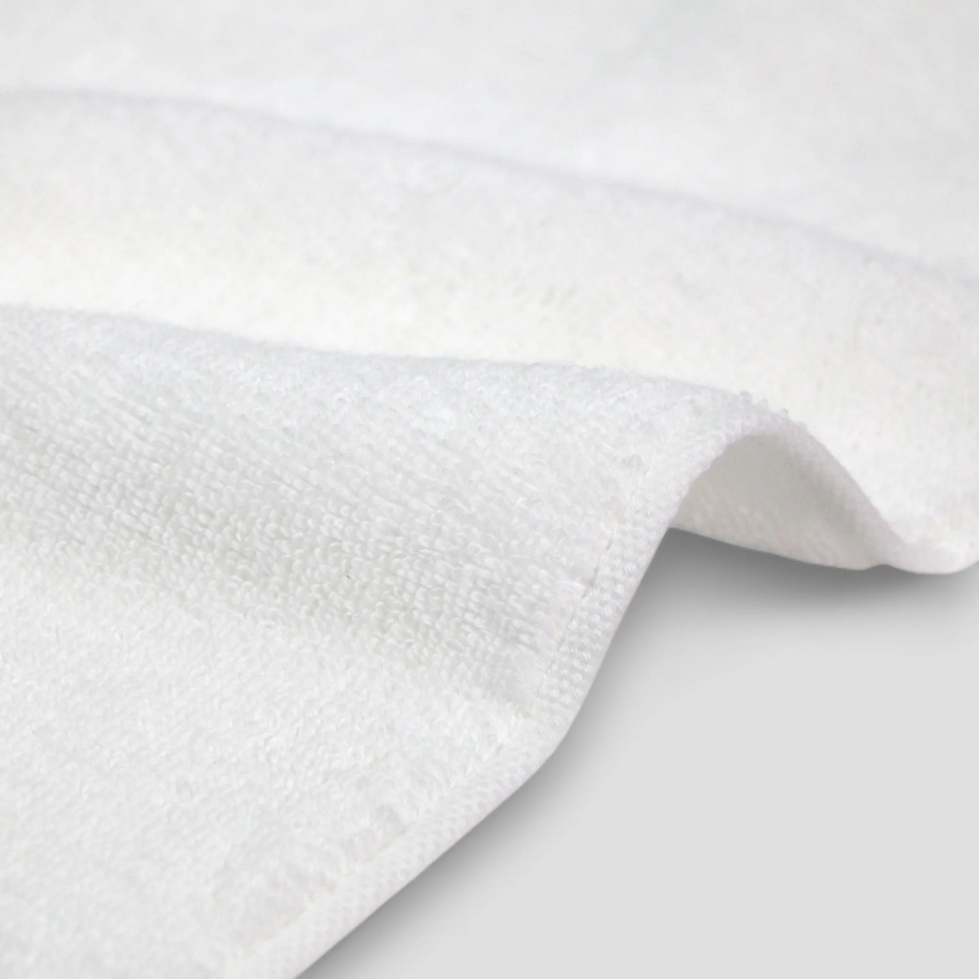 Close-up of white Imabari towel textured fabric on a light gray background