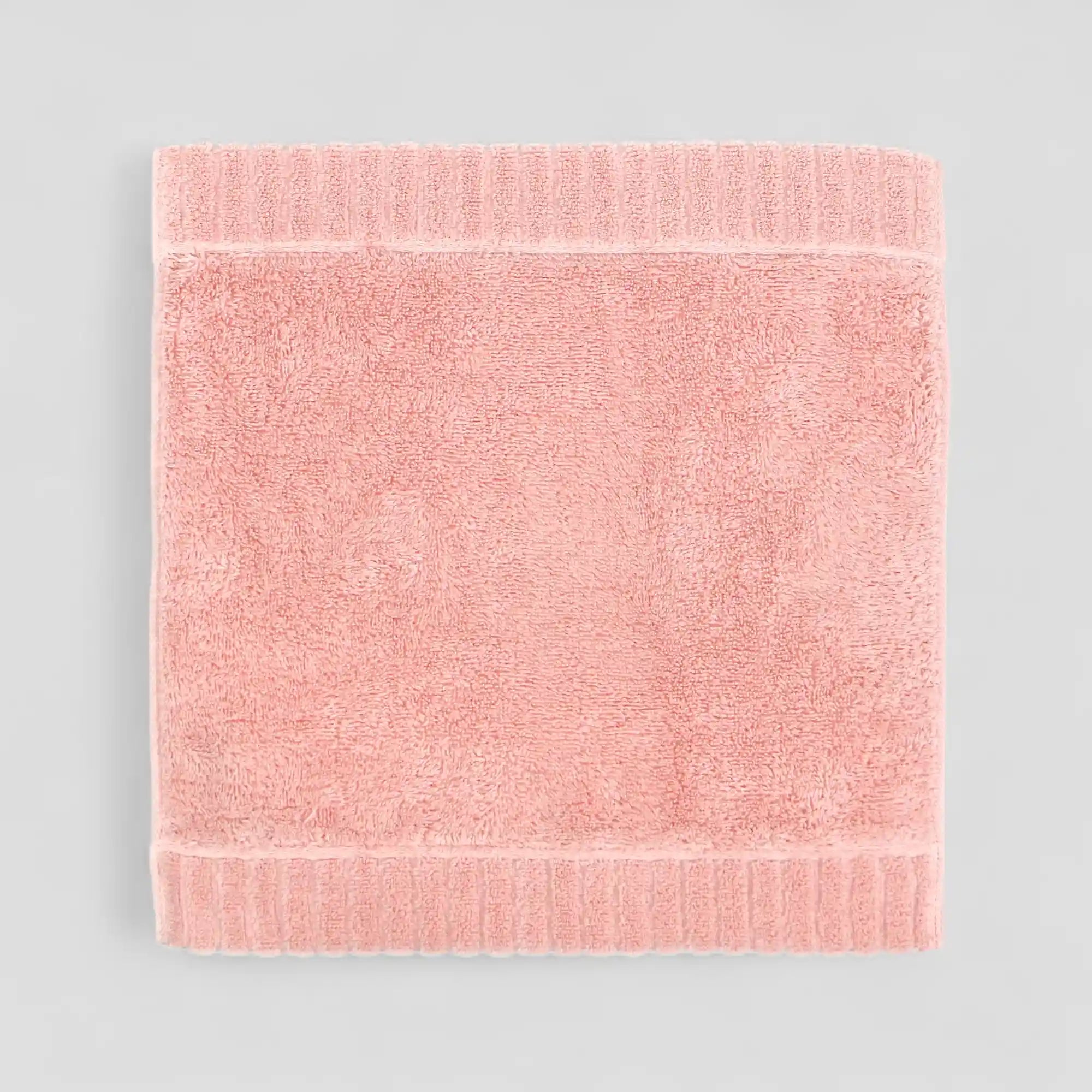 Pink Imabari towel on a light gray background