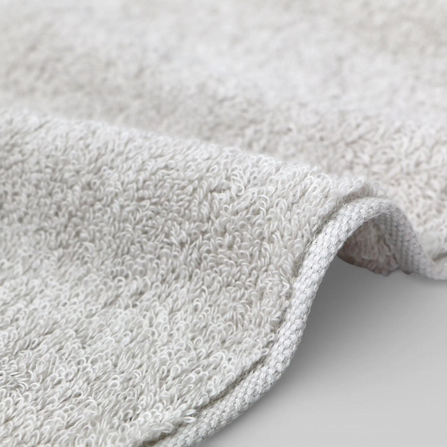 Close-up of a textured gray Imabari towel on a light gray background