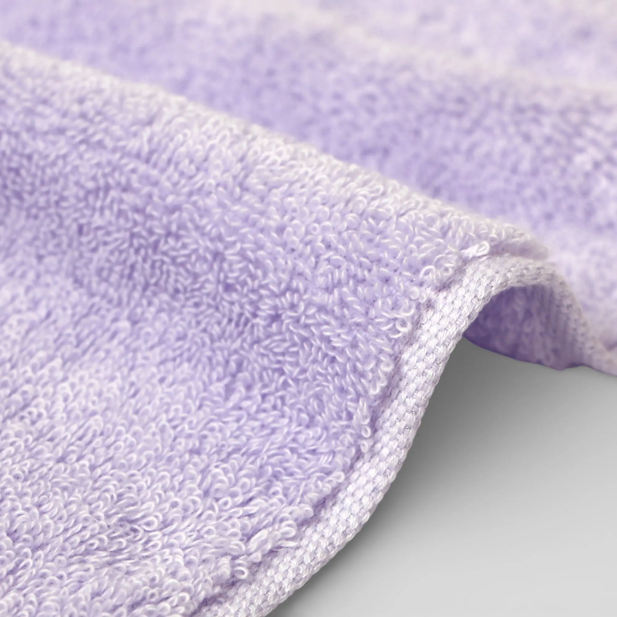 Close-up of a purple Imabari towel textured on a light gray background
