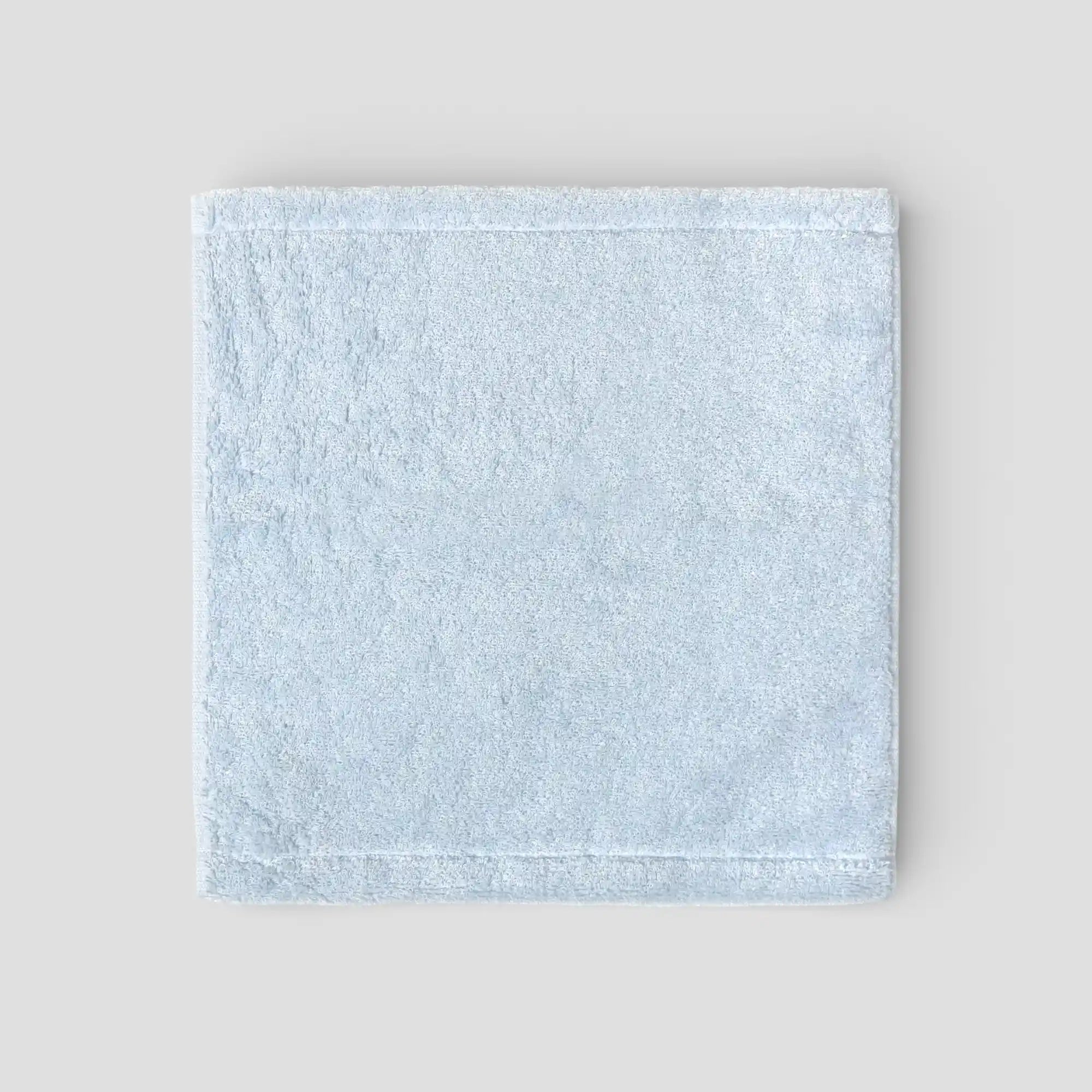 Light blue Imabari towel on a light gray background