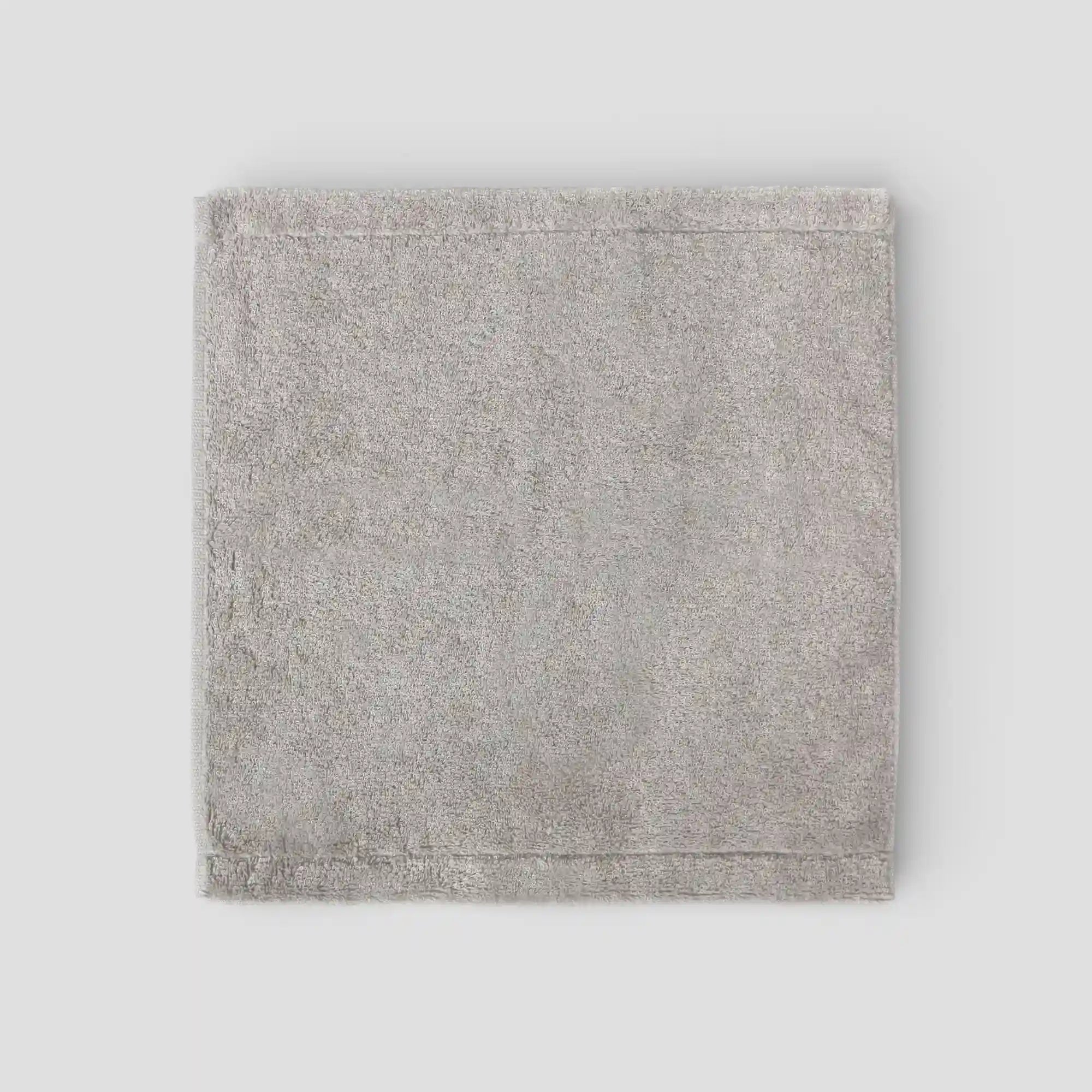 Gray textured fabric square Imabari towel on a light gray background